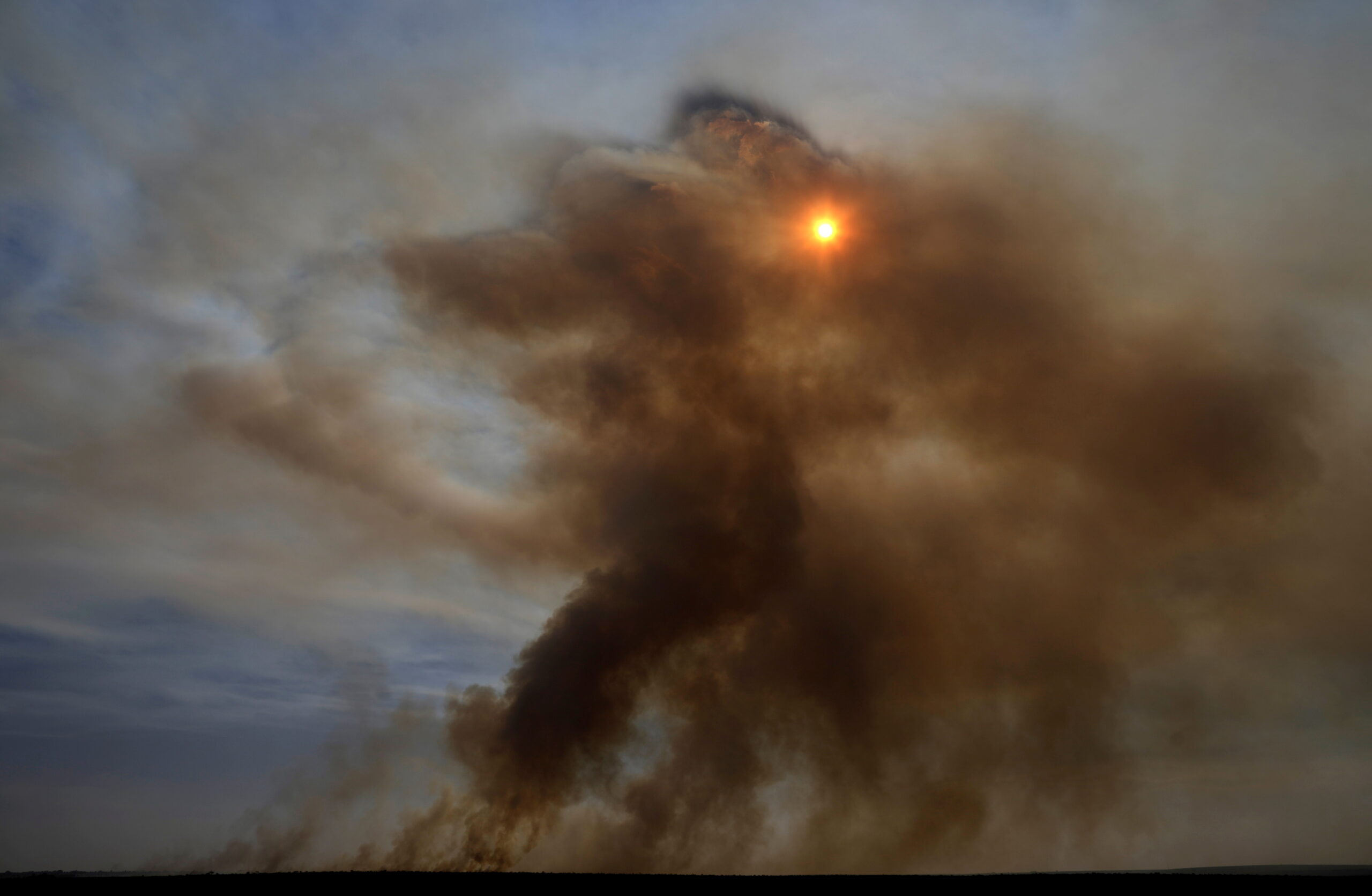 FILE PHOTO: Smoke rises during drought, high temperatures and low humidity in Brasilia