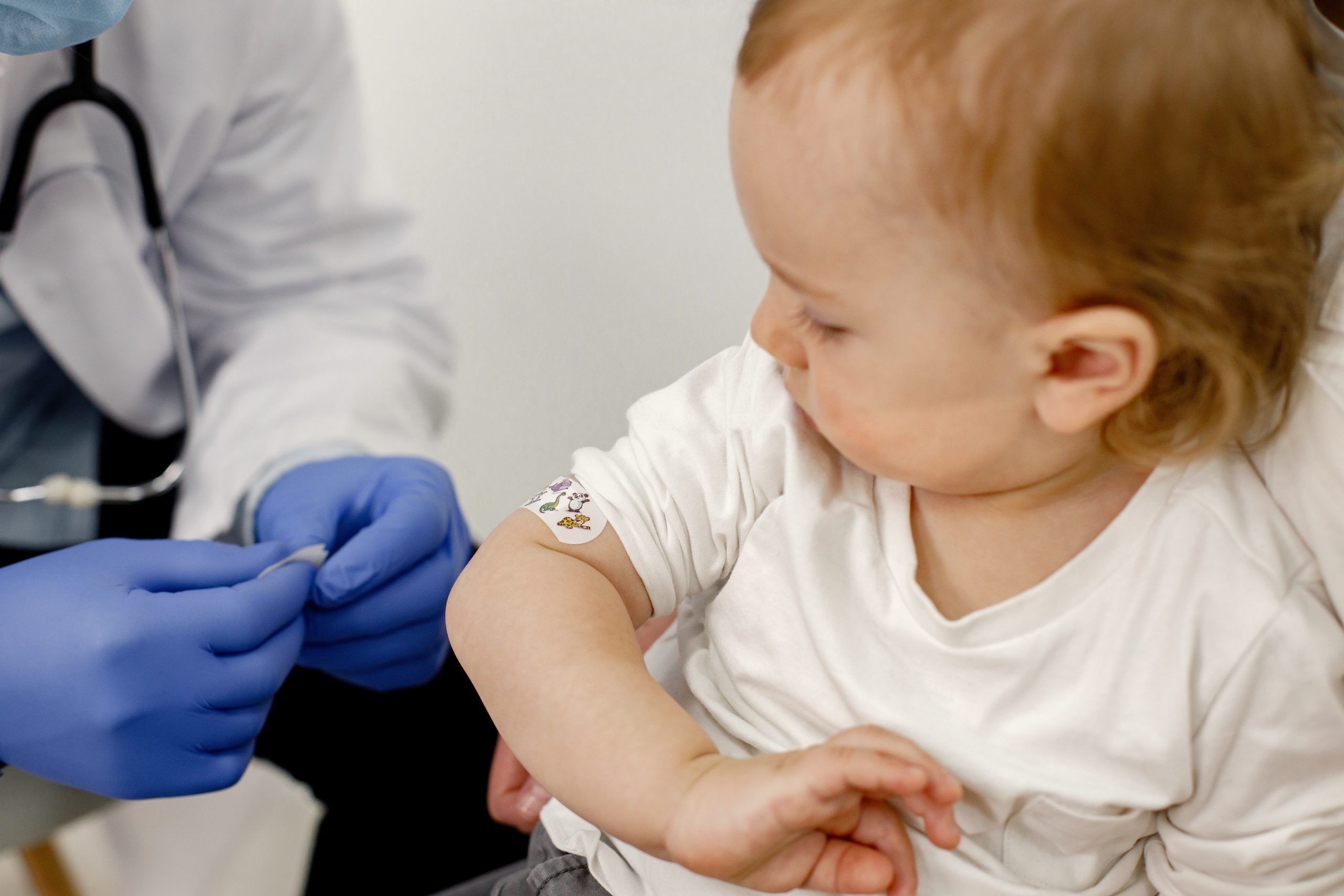 Cropped photo of a boy’s shoulder with stick band-aid vaccinatio