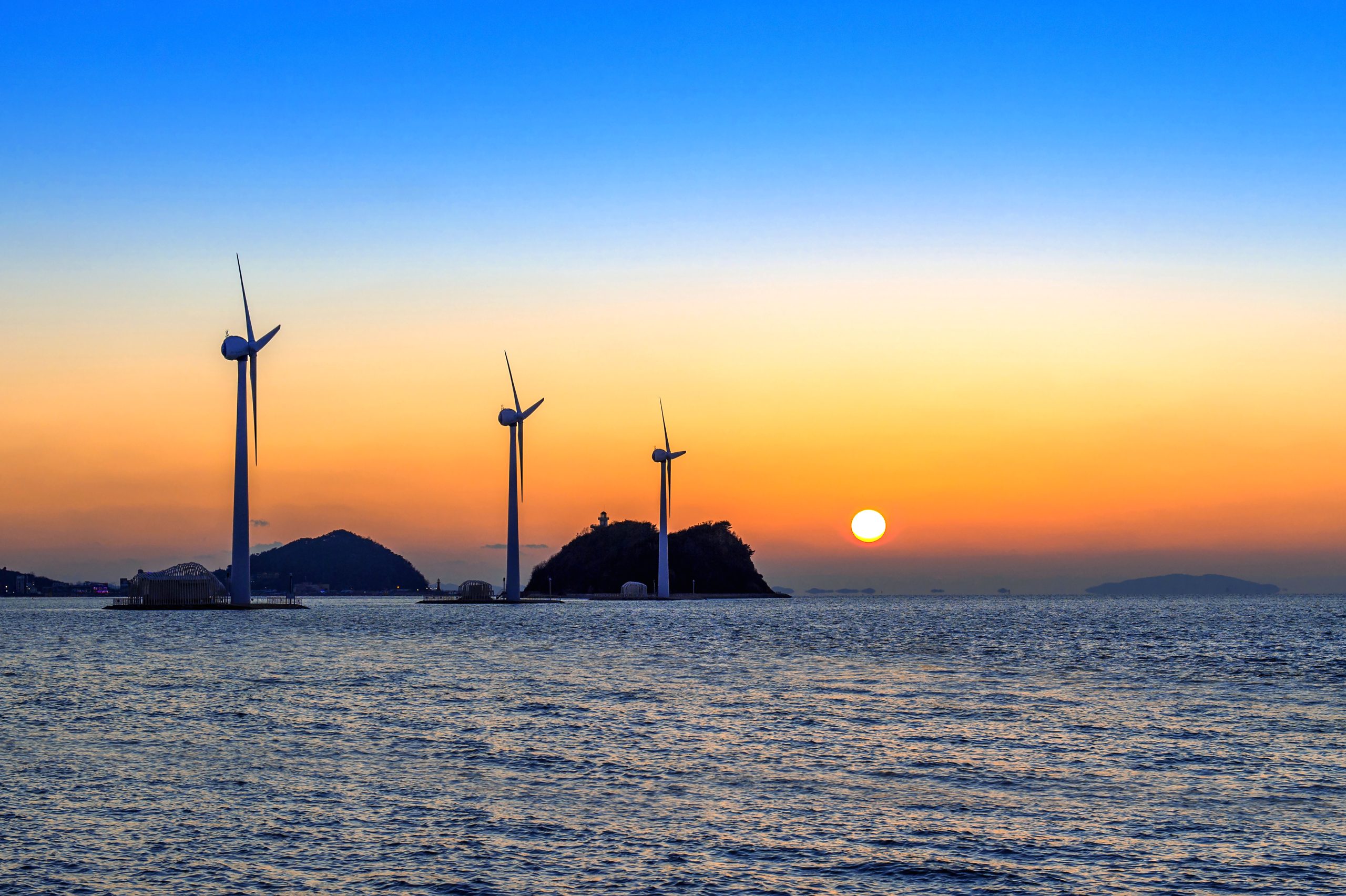Wind turbines generating electricity at sunset in Korea.
