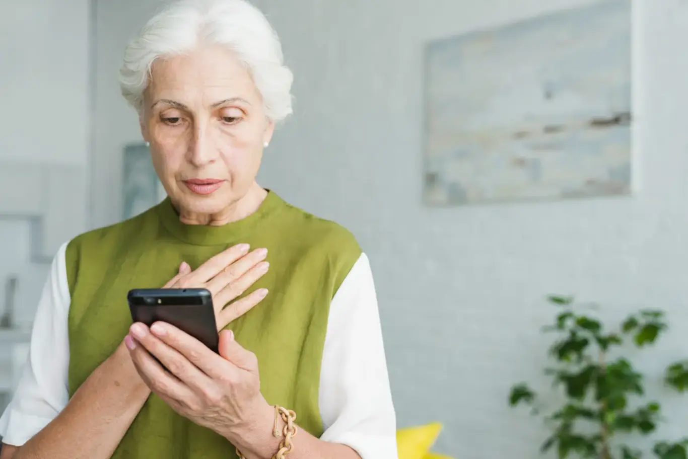 worried-senior-woman-looking-at-smartphone